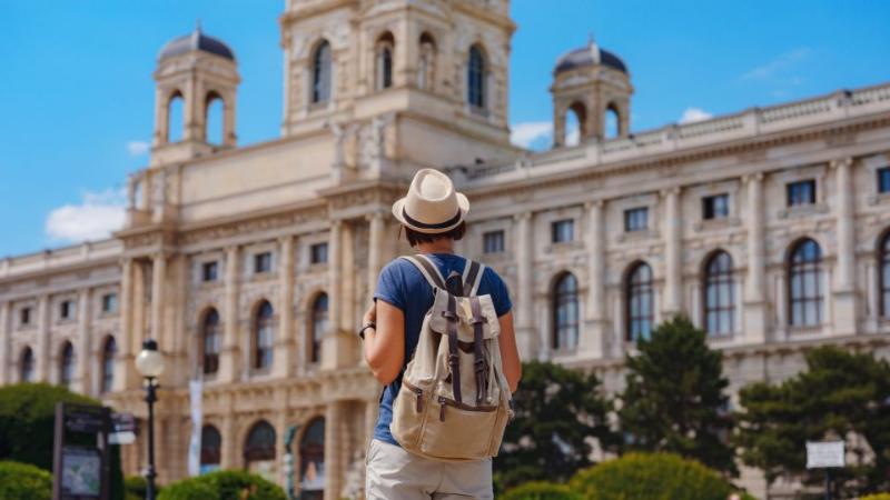 student standing in a sunny European town